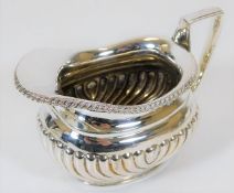 A white metal creamer with gadrooned sides 130g