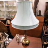 A decorative brass table lamp with shade