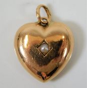 An antique 14ct gold heart pendant set with pearl