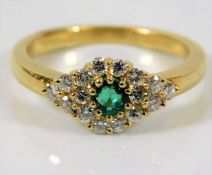 A yellow metal ring, tests as 18ct gold, set with approx.0.33ct diamond & emerald 4.1g size N