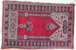 An Islamic prayer rug 60in x 39in