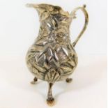 An ornate footed silver creamer 107g