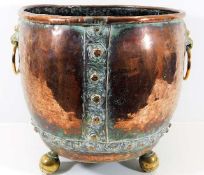 A 19thC. riveted copper log basket with brass lion