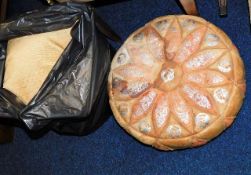 A leather footstool & a bagged quantity of cushion