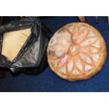 A leather footstool & a bagged quantity of cushion