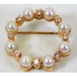 An 18ct gold brooch set with pearl & 0.5ct diamond