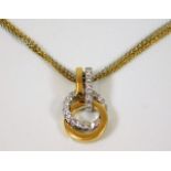 An 18ct two colour gold pendant & necklace set wit