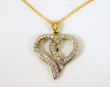 A 9ct gold chain & heart shaped pendant set with a