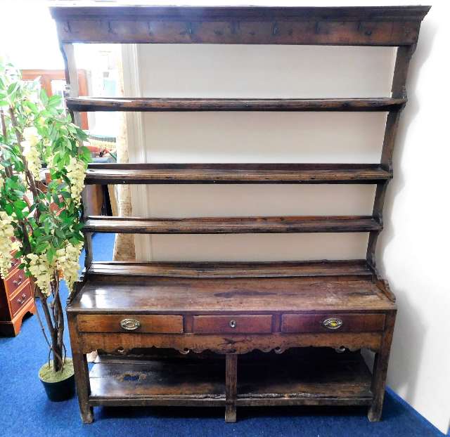 A 17thC. rustic oak dresser with three drawers H76