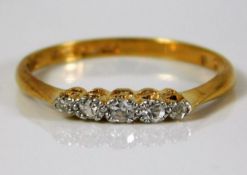 An 18ct gold ring set with five small old cut diam