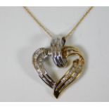 A 9ct gold chain with two tone heart pendant set w