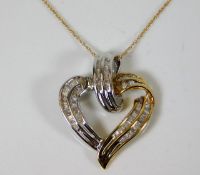 A 9ct gold chain with two tone heart pendant set w