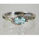 An 18ct white gold ring set with aqua and diamond