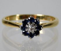 An 18ct gold ring set with diamond and sapphire 2.