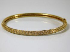 An 18ct gold bangle set with approx. 2ct diamonds 16.1g