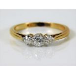 An 18ct gold ring set with three diamonds of approx 0.45ct 2.6g size L