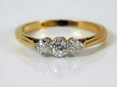 An 18ct gold ring set with three diamonds of approx 0.45ct 2.6g size L