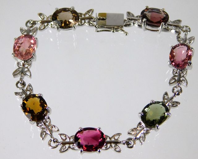 A 9ct white gold bracelet set with fancy tourmalin