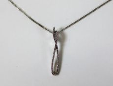 A 9ct white gold chain and pendant set with diamon