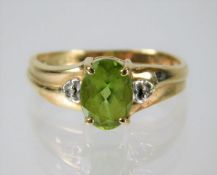 A 9ct gold peridot and diamond ring 2.3g size M