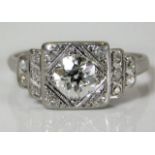 An art deco period platinum ring set with diamonds with an old cut centre diamond of good colour & c