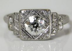 An art deco period platinum ring set with diamonds with an old cut centre diamond of good colour & c