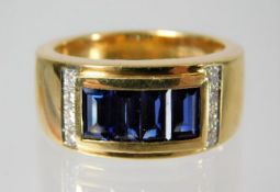An 18ct gold ring set with diamonds and baguette cut sapphires