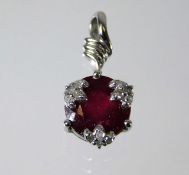 A 9ct gold pendant set with diamonds and ruby 1.4g