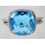 A 14ct white gold ring set with diamond and 'London Blue' topaz 7.2g size M