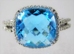 A 14ct white gold ring set with diamond and 'London Blue' topaz 7.2g size M