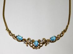 A 9ct gold necklace set with diamond and topaz 8.2