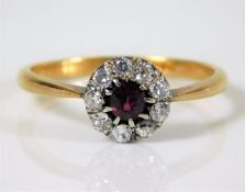 An 18ct gold ring diamond & ruby ring set with 0.4