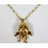 A 9ct gold humpty dumpty pendant & chain set with