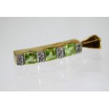 A 9ct gold pendant set with peridot and eight small diamonds 0.7g