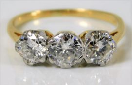 A yellow metal trilogy ring, tests as 18ct gold, w