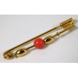 A 1920's style 18ct gold brooch set with coral 1.6