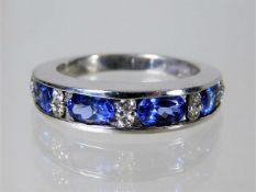 An 18ct gold ring set with tanzanite and 0.2ct dia