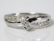 A 9ct white gold ring set with fifteen diamonds 2g