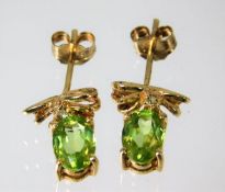 A pair of 9ct gold peridot and diamond earrings 1.9