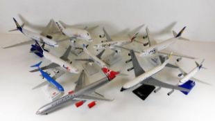 Ten diecast model aeroplanes with stands