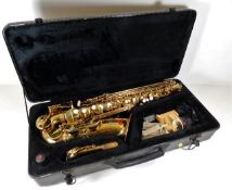 A cased Roy Benson Saxophone with accessories