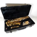 A cased Roy Benson Saxophone with accessories