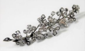A 9ct white gold brooch of organic form set with approx. 42 diamonds 6.8g
