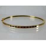 A 10ct gold bangle set with approx. 0.2ct diamond