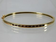 A 10ct gold bangle set with approx. 0.2ct diamond