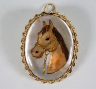 A 9ct gold mother of pearl brooch with hand painted intaglio style carved horse decor 22.4g