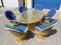 A cane style garden suite of six chairs with cushi