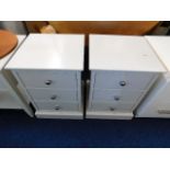 A pair of bedside cabinets, one with damaged top