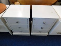 A pair of bedside cabinets, one with damaged top