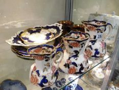 A set of three Masons Ironstone graduated jugs in the Mandalay pattern, two Doulton cabinet plates,